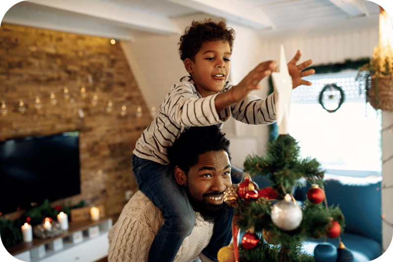 A father and son decorate the tree for the holidays. Community Choice Credit Union - Michigan A father and son decorate the tree for the holidays. Community Choice Credit Union - Michigan